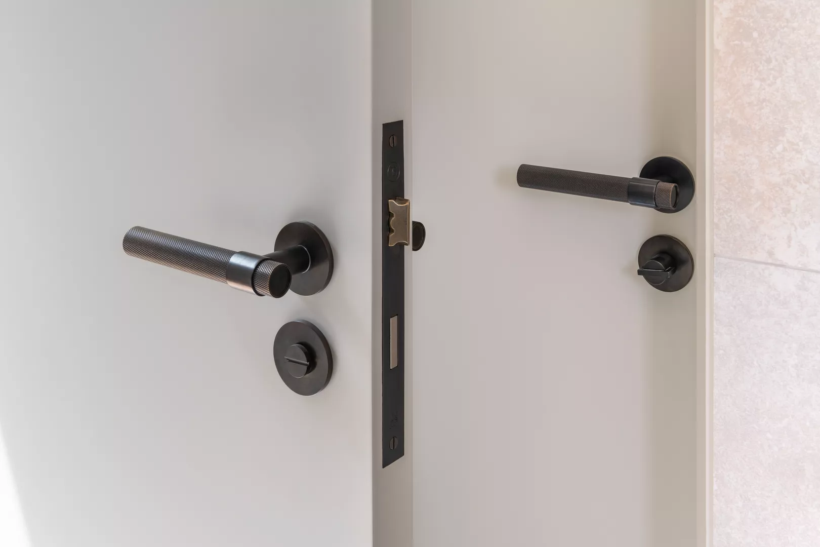 3 Peek Crescent - Hallway with Montgomery Diamond Knurled Lever (LV1142), Bailey Privacy Turn (TT1066) & Release (RL1015) in Dark Bronze Waxed - DBZW