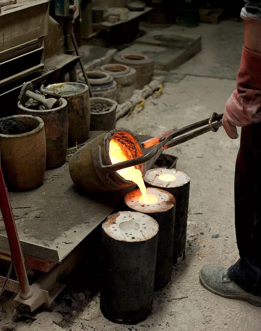 Manufacturing image in the workshop showing the melting down of raw brass to recycle and repurpose into a new brass product.