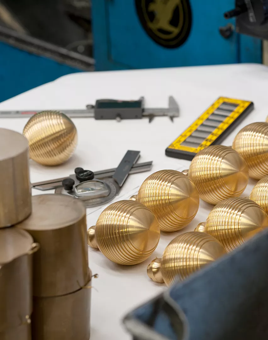 Production and assembly of unfinished Granville solid brass door knobs with workshop equipment.