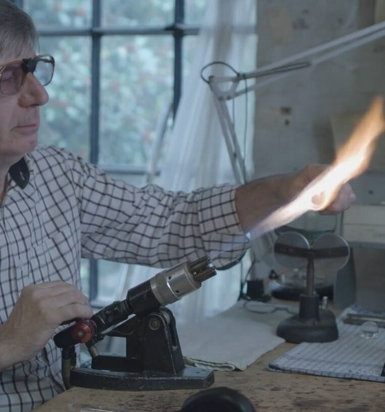 One of our British craftsmen for our glass hardware products in his workshop using a blowtorch to work on a piece.