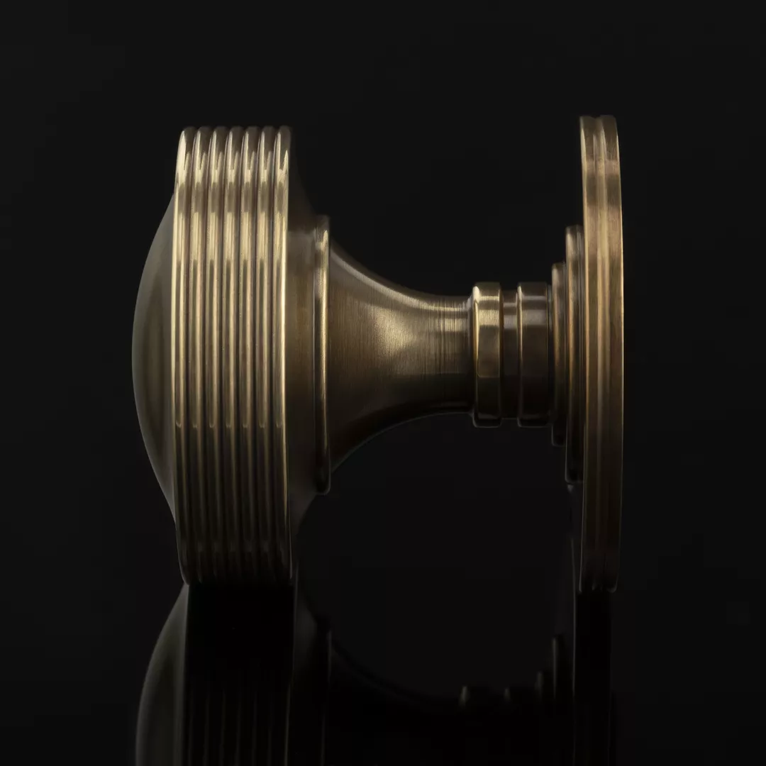 Arty Shot of Bespoke Reeded Door Knob (SP14154) in Mid Antique Brass Waxed - MABW on a black background