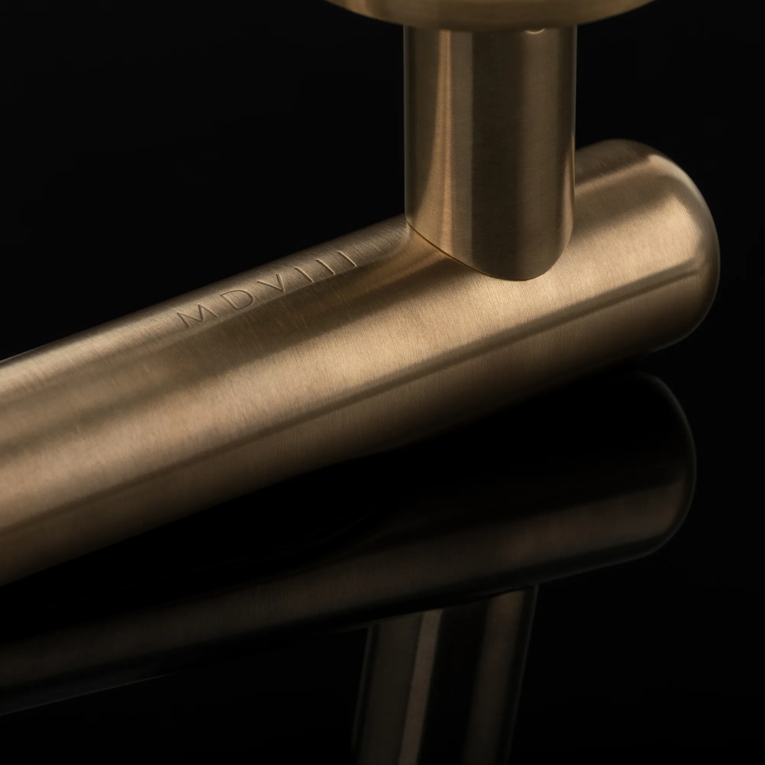 Arty Shot of Contour Lever, showing engraving on the back (LV1217, LV1219) in Mid Antique Brass Waxed - MABW