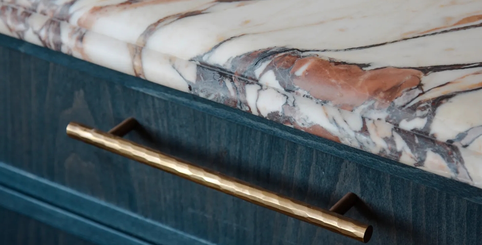 Bay House - Kitchen with Close Up of Rolled & Hammered Cabinet Handles (CH1012) in Mid Antique Brass Waxed - MABW