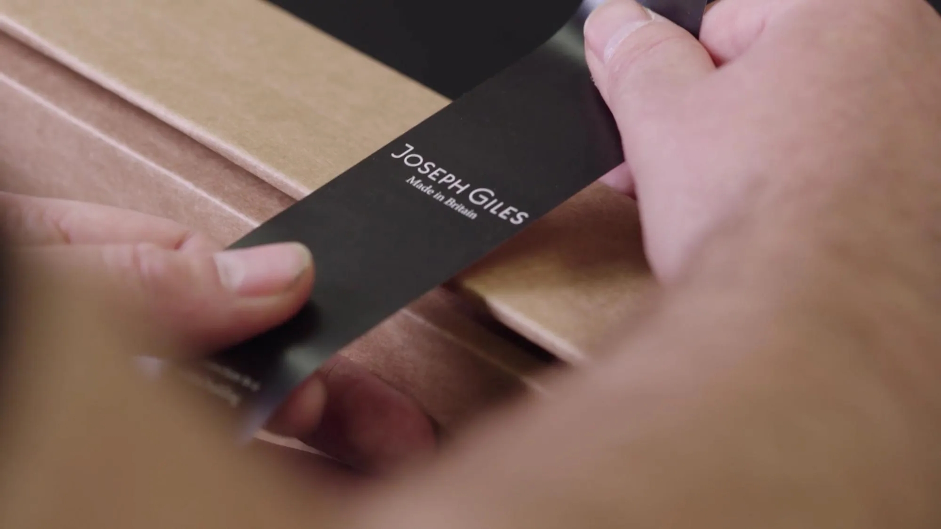 Packing products in cardboard box complete with a sticker and ready for delivery.