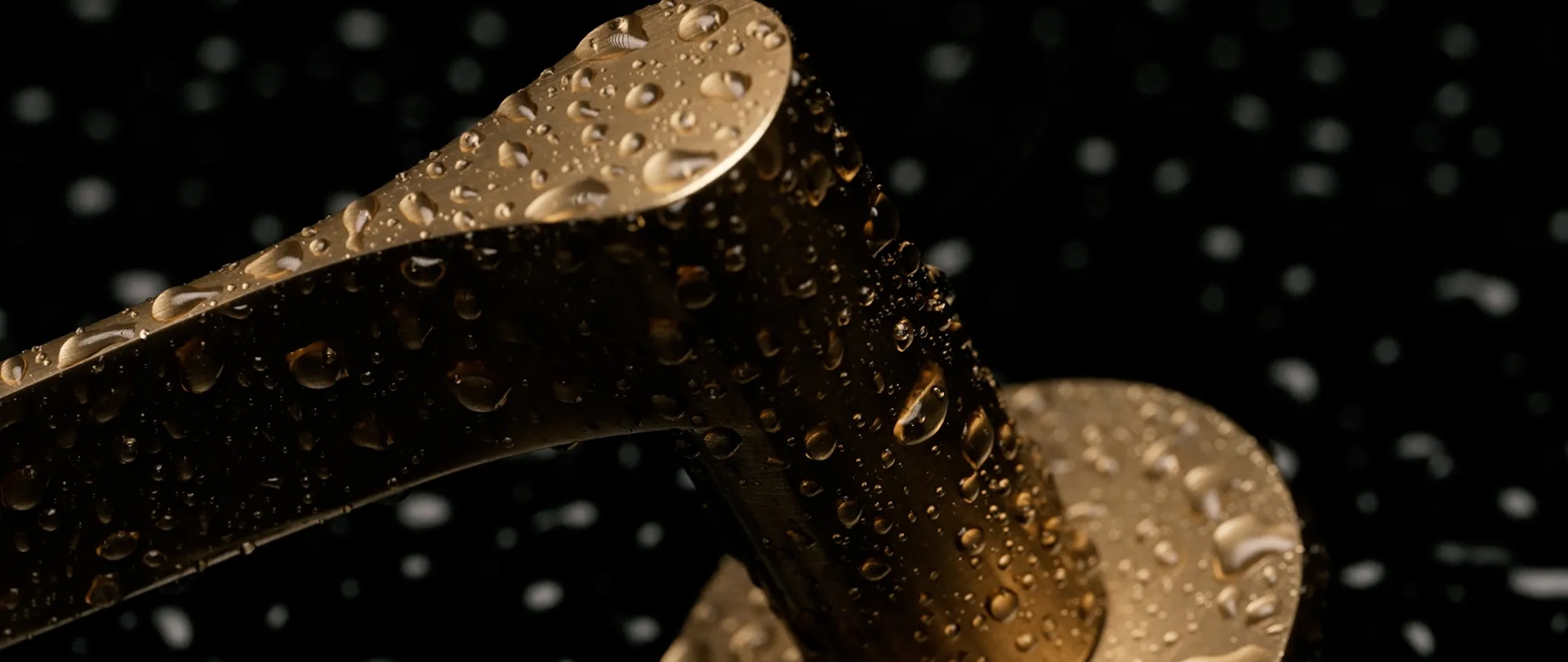 Ceramic - Close Up of Fonteyn Lever (LV1045) in Mid Antique Brass Ceramic - CMAB with water (landscape)