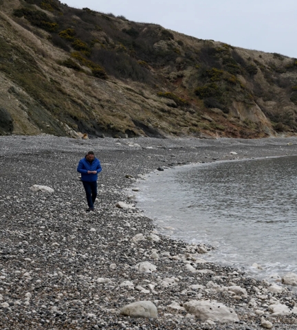 Cove Inspo - Mark Harper walking along the beach at Lulworth Cove
