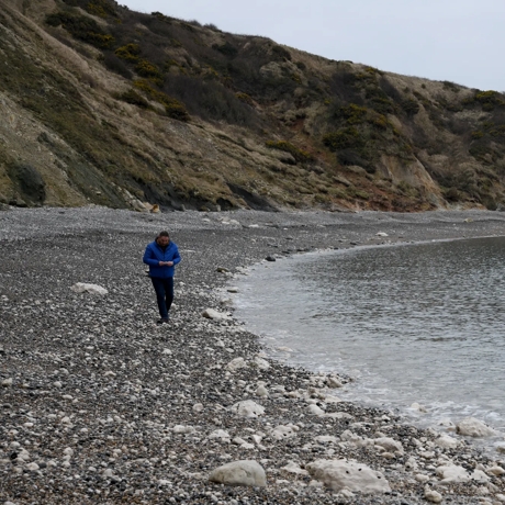 Cove Inspo - Mark Harper walking along the beach at Lulworth Cove