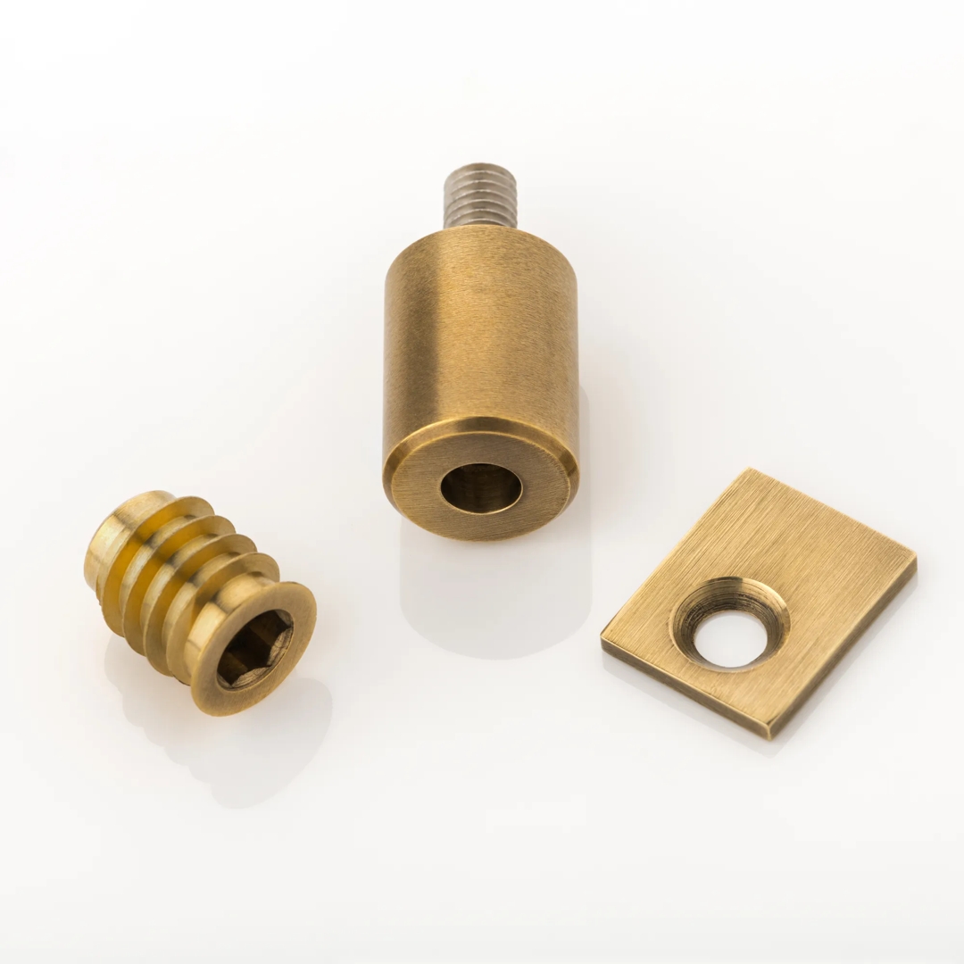 Pair of Sash Window Removable Stops (WN1074) in Brushed Brass Waxed - BBW on a white background.
