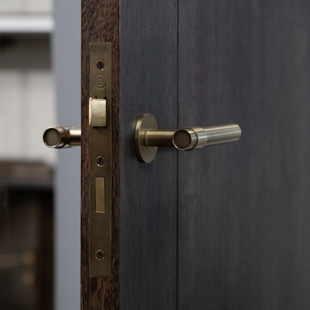 Double Door Installation Shot of Montgomery Lever & Back Plate - Euro Cut Out (LV1212) in Mid Antique Brass Waxed - MABW