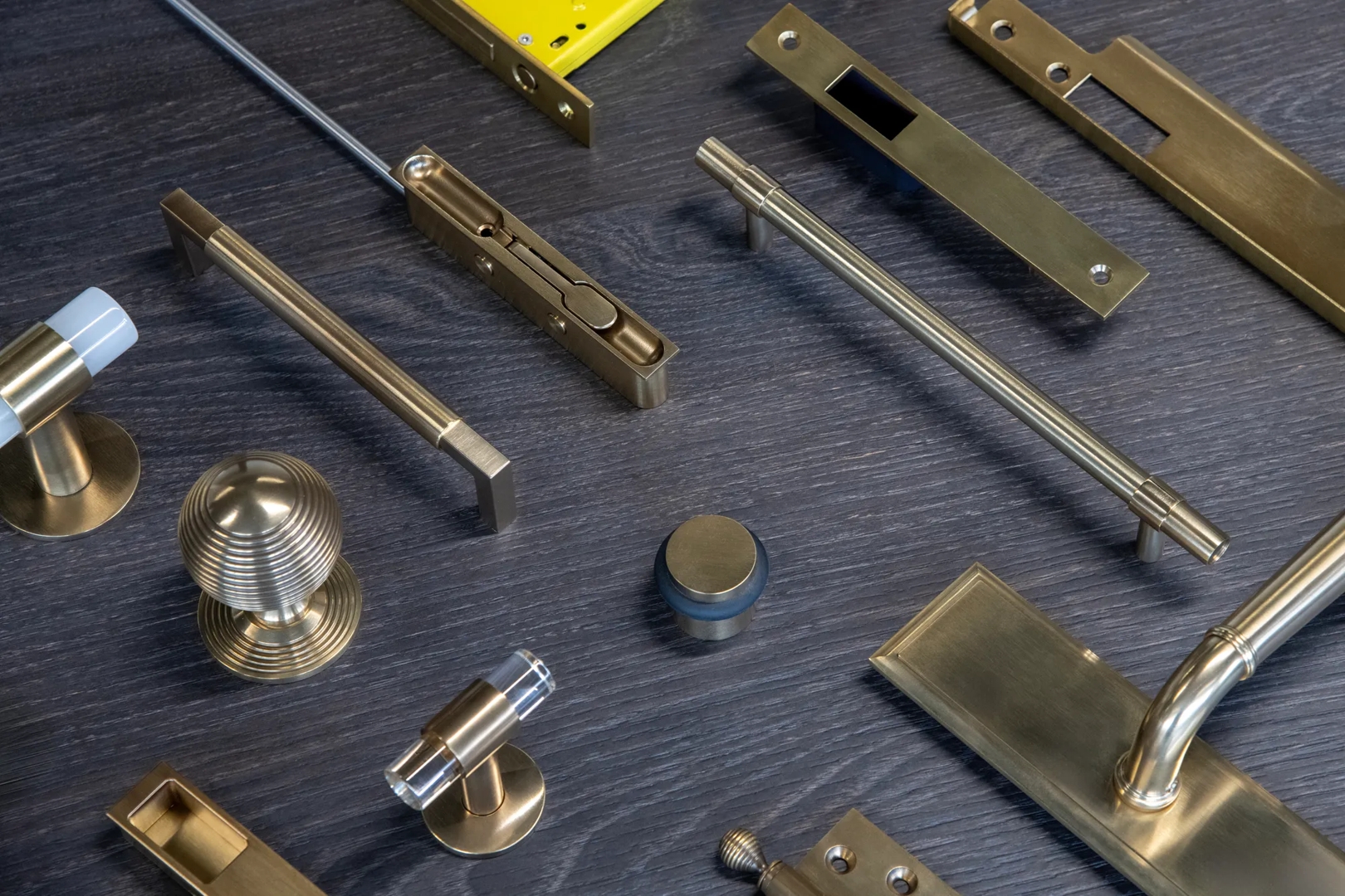 Door and Cabinet Hardware in Mid Antique Brass Waxed - MABW on Flat Lay