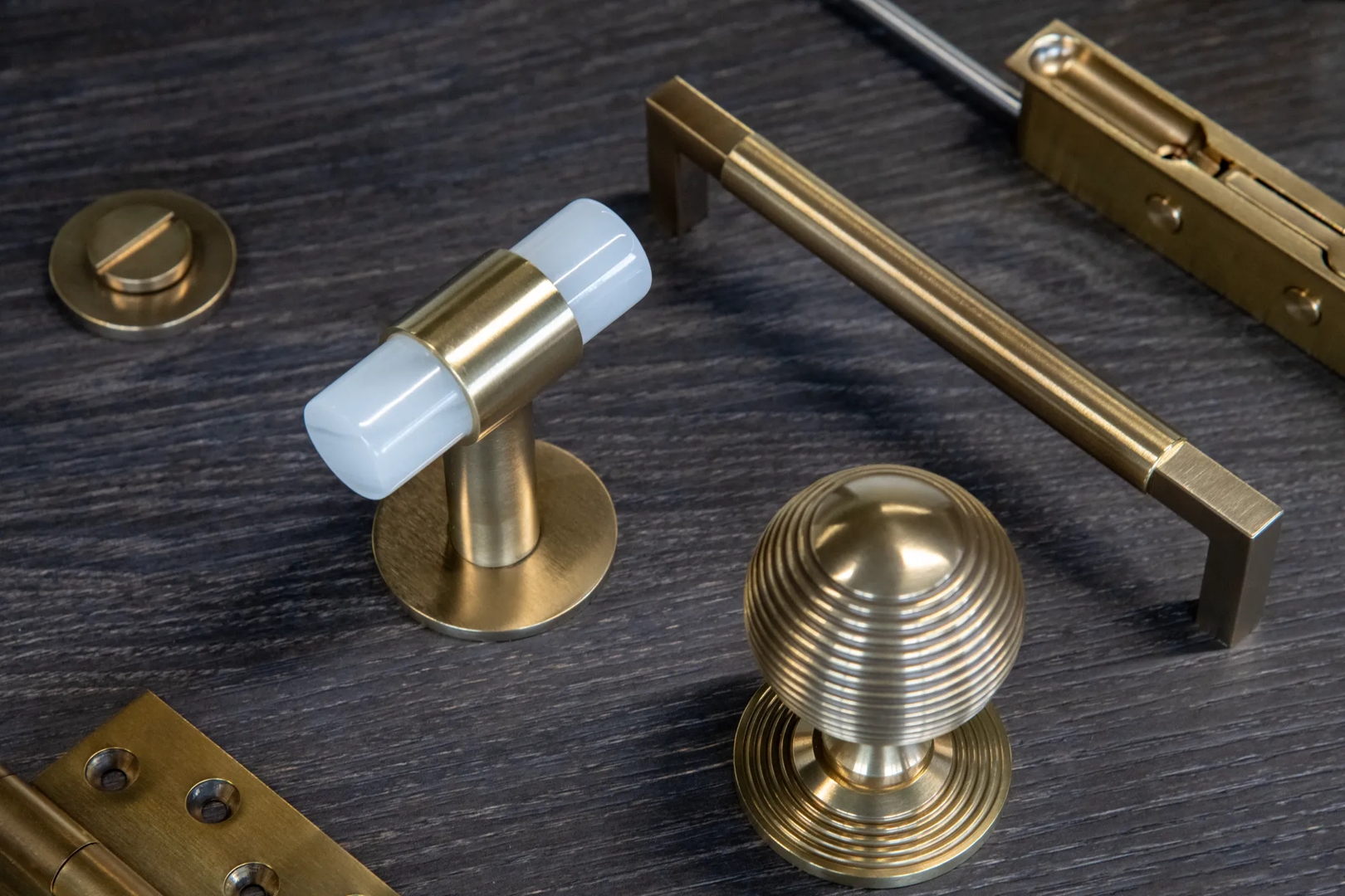 Door and Cabinet Hardware in Mid Antique Brass Waxed - MABW on Flat Lay