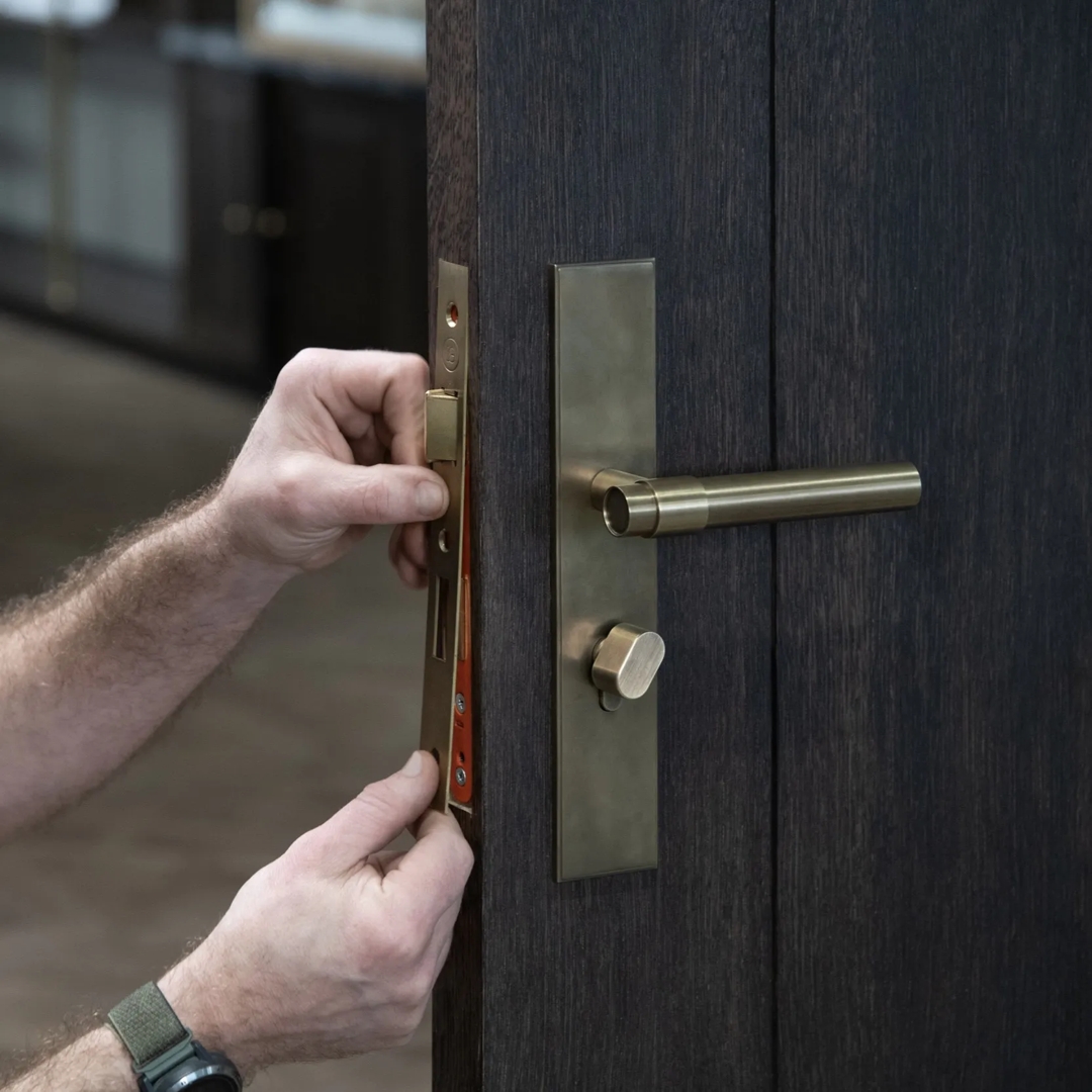 Double Door Installation Shot of Montgomery Lever & Back Plate - Euro Cut Out (LV1212) in Mid Antique Brass Waxed - MABW